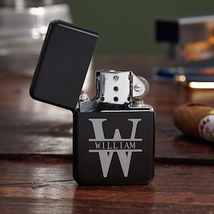 May include: Black lighter with a silver engraved initial "W" and the name "William" below it.