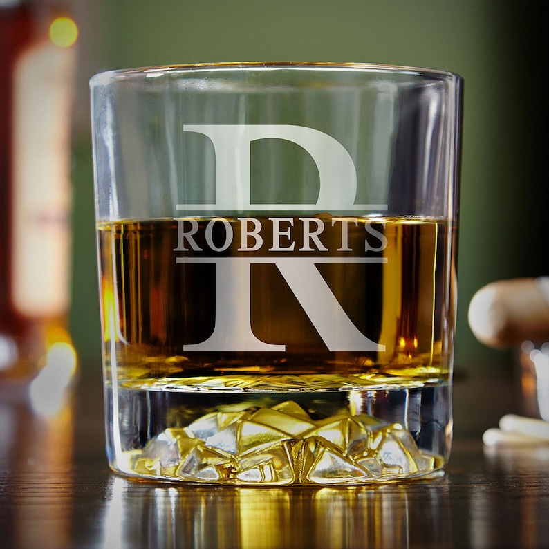 Single whiskey glass showing sturdy, clear glass features a heavy base and elegant etching, perfect for serving whiskey, bourbon, or other fine spirits. Ideal for gifting on special occasions like weddings, Father's Day, or as a unique groomsmen gift