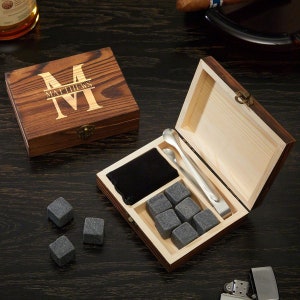 Personalized wooden whiskey box with whiskey stones and a pair of tongs inside.
