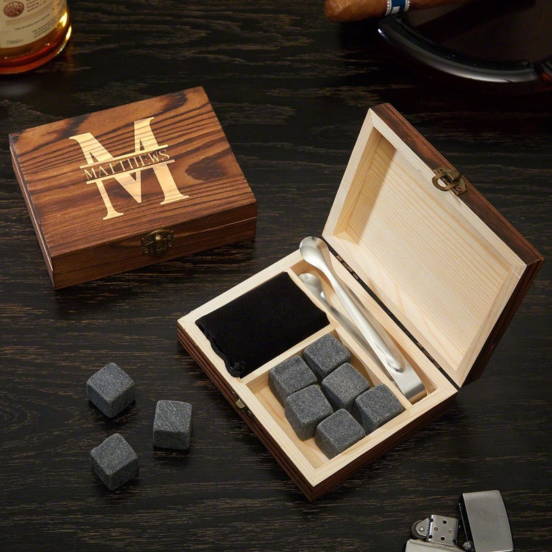 Personalized wooden whiskey box with whiskey stones and a pair of tongs inside.