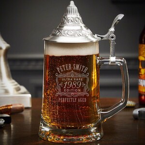 Close-up of engraved German beer stein with personalized design.