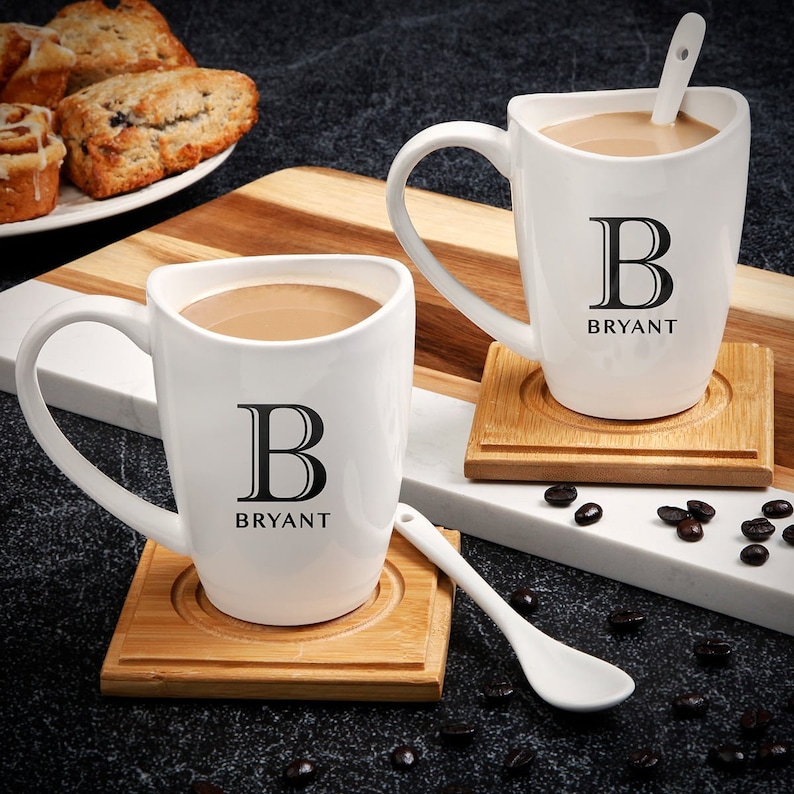 Two custom coffee mugs with two mixing spoons and two coasters.