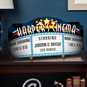 Close-up of home theater sign with title and three phrases.