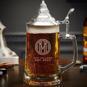 Close-up of engraved German beer stein with personalized design.