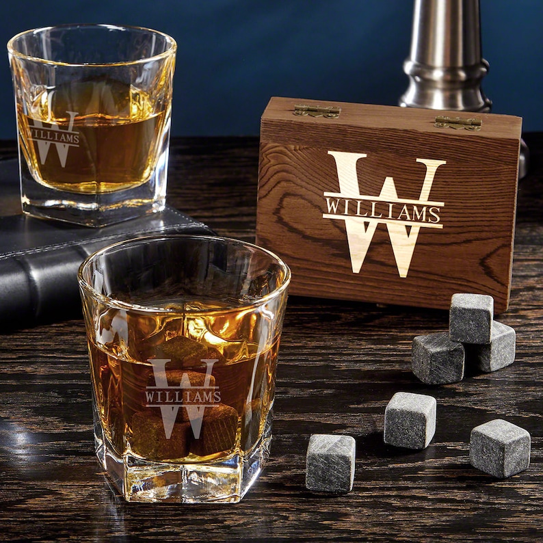 Two personalized whiskey glasses with a matching wooden gift box and six whiskey stones.