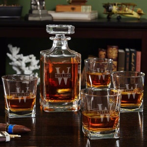 May include: A personalised decanter and four whisky glasses with the name "William" etched on each piece. The decanter is filled with amber liquid and the glasses are filled with a clear liquid.