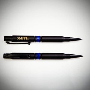Two custom .308 Bullet Pens with Thin Blue Line design with engraved name on one pen.