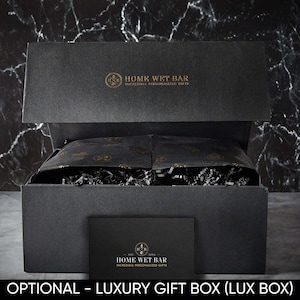 May include: A black gift box with a gold logo that says "Home Wet Bar - Incredible Personalized Gifts". The box is open and filled with black tissue paper and shredded paper.
