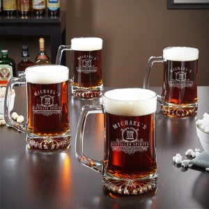 Set of four engraved beer glasses.
