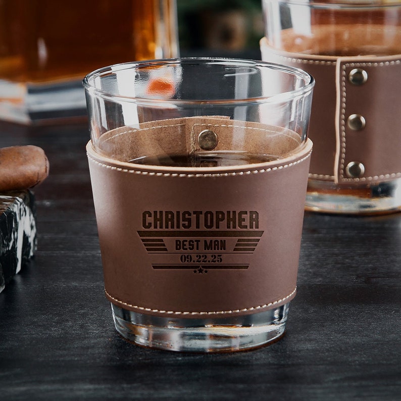 Detailed view of etched leather wrap on whiskey glass, showing personalized design options.