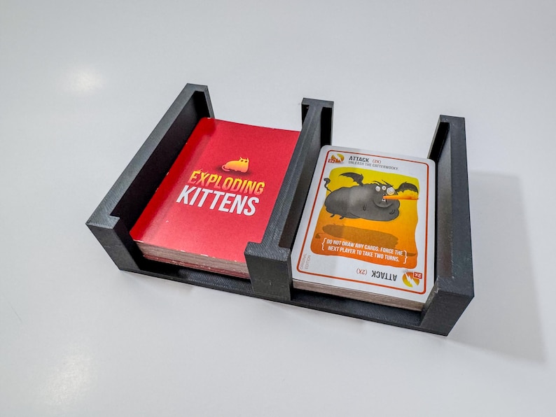 Exploding Kittens game box organizer insert. It is shown in black with the Exploding Kittens Game.