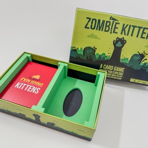 Exploding Kittens game box organizer insert. It is shown in green with the Zombie Kittens Game in the original box.