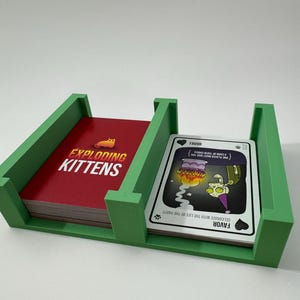 Exploding Kittens game box organizer insert. It is shown in green with the Zombie Kittens Game.