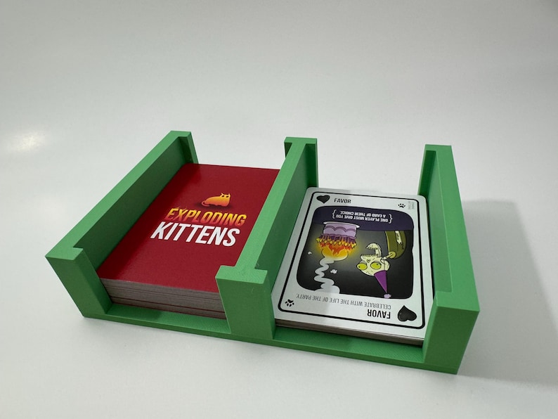 Exploding Kittens game box organizer insert. It is shown in green with the Zombie Kittens Game.