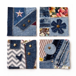 May include: Four square denim patches with various designs. One features a red and white star, another a denim flower, a third a chevron pattern with a heart, and the last a circle with a star. Each patch has gold star embellishments.