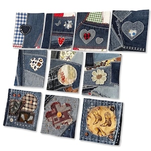 May include: A collection of handmade denim notebooks with patchwork designs. Each notebook features unique embellishments like hearts, flowers, and patterned fabrics. The denim is various shades of blue, with contrasting stitching and decorative elements.