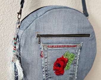 Upcycled denim jeans boho Round Crossbody bag with zipper and pockets.