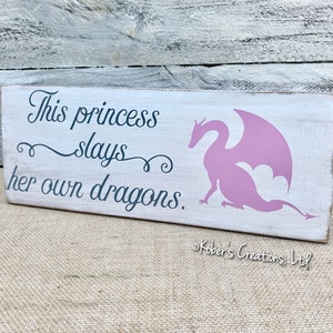 "This Princess Slays Her Own Dragons" Wall Decal - 26.29"x22", Black Vinyl, Removable Quote