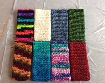 May include: Ten crocheted phone cases in various colors and patterns, including green, blue, red, white, and multi-colored.