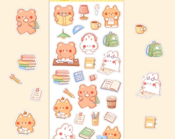 以下が含まれることがあります： クマ、猫、ウサギなどの可愛い漫画の動物たちが、本、鉛筆、バックパックを使って勉強しているステッカーシート。シートには「Study Friends」と「You Can Do It!」の文字が入っています。