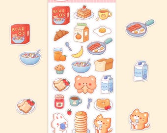 May include: A sheet of stickers featuring cute cartoon illustrations of breakfast foods and animals. The stickers include images of cereal boxes, pancakes, bacon, eggs, toast, milk cartons, juice boxes, and a bear and cat holding food. The text "Breakfast Friends" is at the top of the sheet.