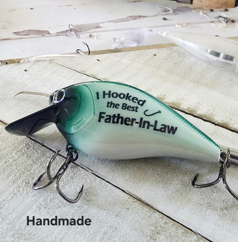 A handmade fishing lure with the text "I Hooked the Best Father-in-Law" printed on it.