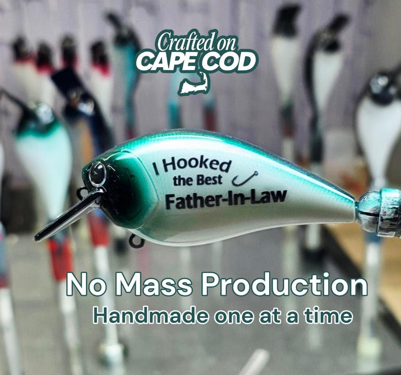 A close-up of a fishing lure with the text "I Hooked the Best Father-In-Law" printed on it, along with the text "No Mass Production Handmade one at a time" below it.