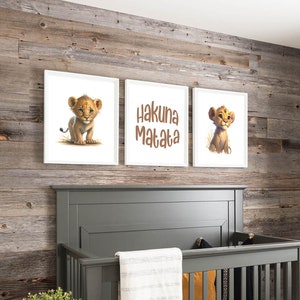 Peut inclure: Trois impressions encadrées avec un fond blanc et des cadres blancs. Les impressions de gauche et de droite présentent un lionceau de dessin animé avec une fourrure brune et des yeux bleus. L'impression du milieu présente le texte "Hakuna Matata" en lettres brunes.
