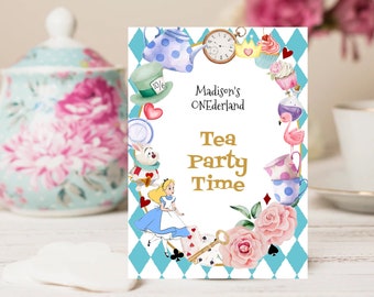 May include: A blue and white tea party invitation with a whimsical Alice in Wonderland theme. The invitation features a teapot, a clock, a cupcake, a flamingo, a playing card, a key, and a rose. The text on the invitation reads "Madison's ONEderland Tea Party Time".