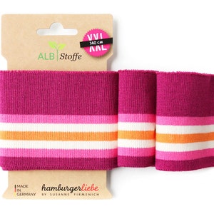 Könnte beinhalten: Rosa, weiß und orange gestreiftes Strickbündchen, 140 cm lang, mit einem Etikett mit der Aufschrift "ALB Stoffe" und "hamburgerliebe by Susanne Firmenich".