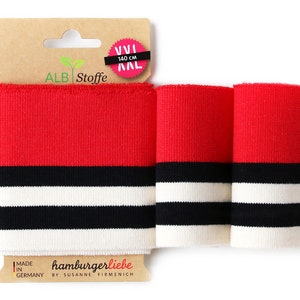 Könnte beinhalten: Rot-weiß gestrickte Bündchen mit schwarzen Streifen. Das Bündchen ist 140 cm lang und wird in Deutschland von hamburgerliebe hergestellt.