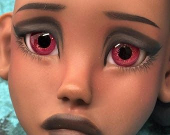 May include: Close-up of a doll's face with striking features. The doll has dark skin, dark gray eyeshadow, and dark gray lipstick. The eyes are a vibrant red with black pupils, framed by long eyelashes. The eyebrows are dark and arched.