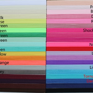 May include: A color chart showing 28 different colors of elastic hair ties. The colors are arranged in two columns. The left column includes colors like white, ivory, cream, buttermilk, chartreuse, apple green, neon green, forest green, pastel green, aqua, mint green, gold yellow, orange, neon orange, grey, metal grey, wine, grape, coffee, and brown. The right column includes colors like peach, pearl pink, baby pink, dark pink, rose pink, mauve, shocking pink, hot pink, azalea, neon pink, red, lavender, lilac, purple, light blue, blue, tornado blue, denim blue, navy, and black.