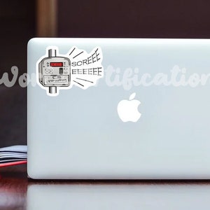 May include: A white laptop computer with a sticker of a utility meter with a red digital display and the word "SCREEEEEE" coming out of it. The laptop has a white Apple logo.