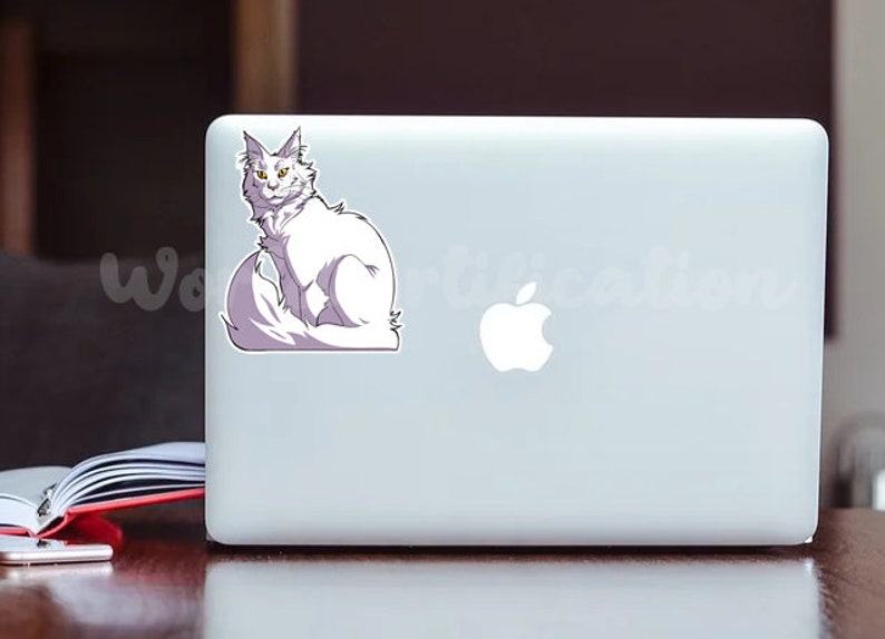 May include: A white cat with yellow eyes sits on a laptop computer. The cat has a fluffy tail and is looking directly at the camera.