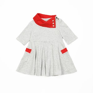 May include: A gray and white striped dress with a red collar and red trim on the pockets. The dress has a button closure at the neck.