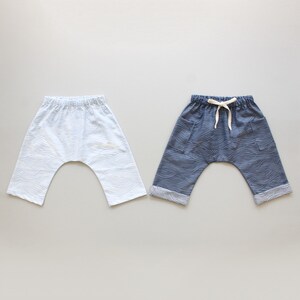 May include: Two pairs of pants with a wave pattern. One pair is light blue and the other is dark blue.