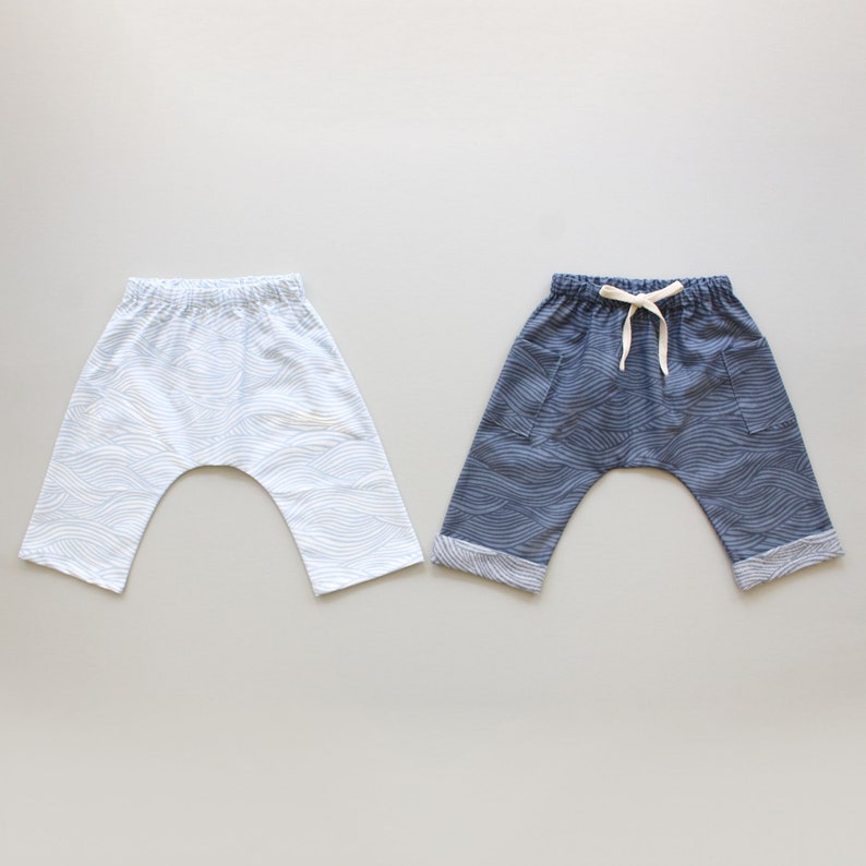 May include: Two pairs of pants with a wave pattern. One pair is light blue and the other is dark blue.