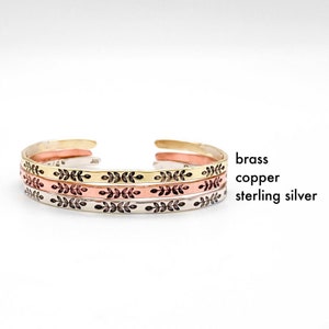 Thin stacking cuff bracelet can be made in gold toned brass, rose toned copper, or sterling silver. Darkened leaf design on front contrasts well on all metal choices.