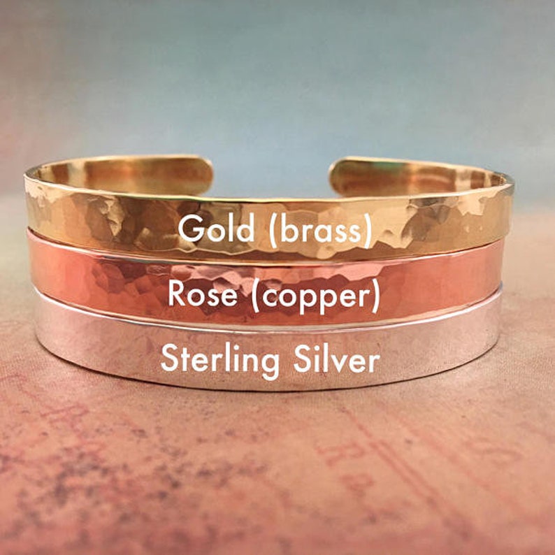 Cuff bracelet metal options are gold toned brass, rose toned copper, and sterling silver. They are lightly hammered for a handmade or artisan look, and can be polished shiny or lightly sanded matte.