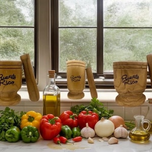 May include: Three wooden mortars and pestles, each engraved with the text Puerto Rico, are arranged with fresh produce including yellow, red, and green bell peppers, white onions, garlic cloves, parsley, and two glass bottles filled with olive oil.
