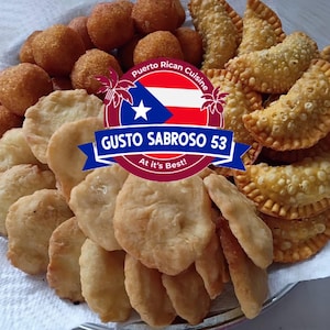 May include: A platter of assorted fried Puerto Rican cuisine, including golden-brown fritters, empanadas, and round, crispy balls. The image features a logo with the Puerto Rican flag and the text "Gusto Sabroso 53".
