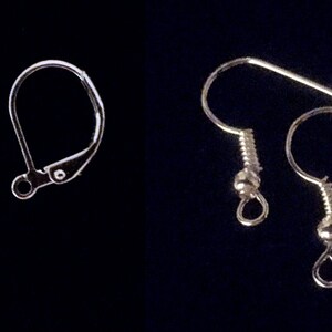May include: Two pairs of earring findings, one pair of leverback closures and one pair of fishhook ear wires. Both pairs are silver in color.