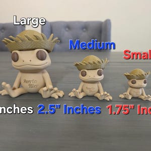 May include: Three beige gecko figurines wearing straw hats, labeled "Large", "Medium", and "Small". The largest is 4 inches tall, the medium is 2.5 inches, and the smallest is 1.75 inches. Each figurine has the words "Puerto Rico" on its chest.