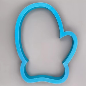 May include: A bright blue mitten-shaped cookie cutter. The cutter is made of plastic and has a smooth, rounded design. The mitten shape is clearly defined, with a thumb and a curved top.