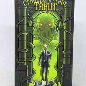 May include: A green and black box with a green and yellow illustration of a tentacled monster and a man in a suit holding a book. The box reads "Cthulhu Mythos Tarot" and "The Cthulhu Project Art by Sandro Fazlinovic".