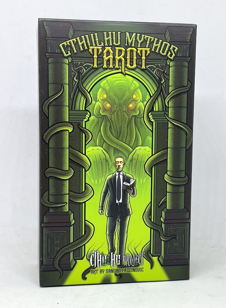 May include: A green and black box with a green and yellow illustration of a tentacled monster and a man in a suit holding a book. The box reads "Cthulhu Mythos Tarot" and "The Cthulhu Project Art by Sandro Fazlinovic".