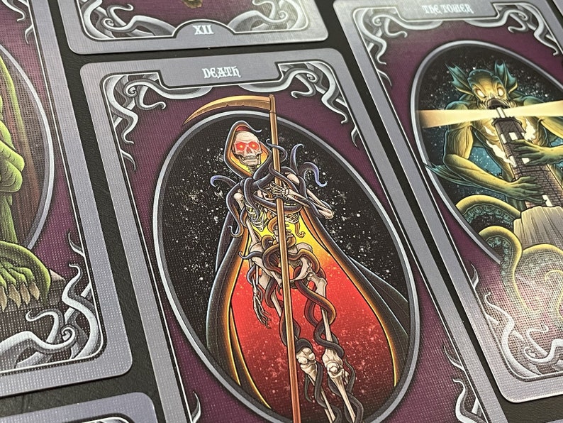 May include: Tarot card depicting Death, the 13th card in the Major Arcana. The card features a skeletal figure in a red and black robe, holding a scythe and surrounded by a swirling mass of tentacles.