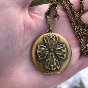 Early 20th century gilt locket with interesting cross design, on original chain, signed FMS co.