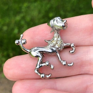 Vintage rhinestone dog brooch. Poodle?